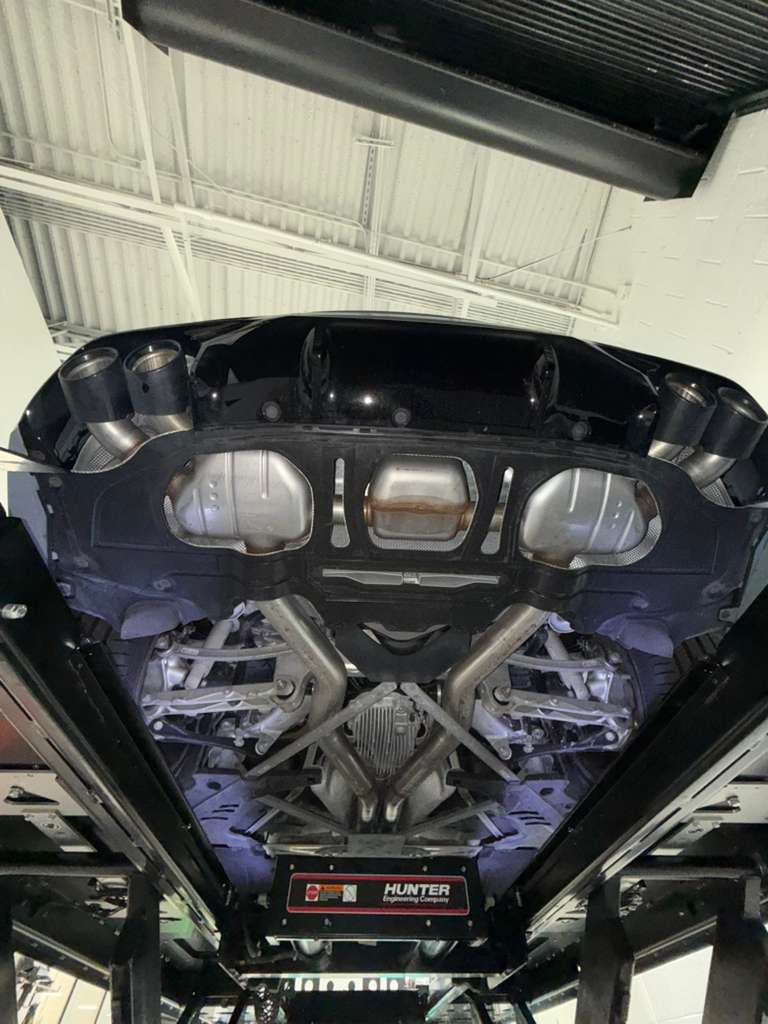 BMW M8 Competition underbody inspected on a vehicle lift