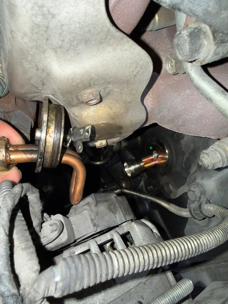 Leaking diesel engine block heater removed for repair